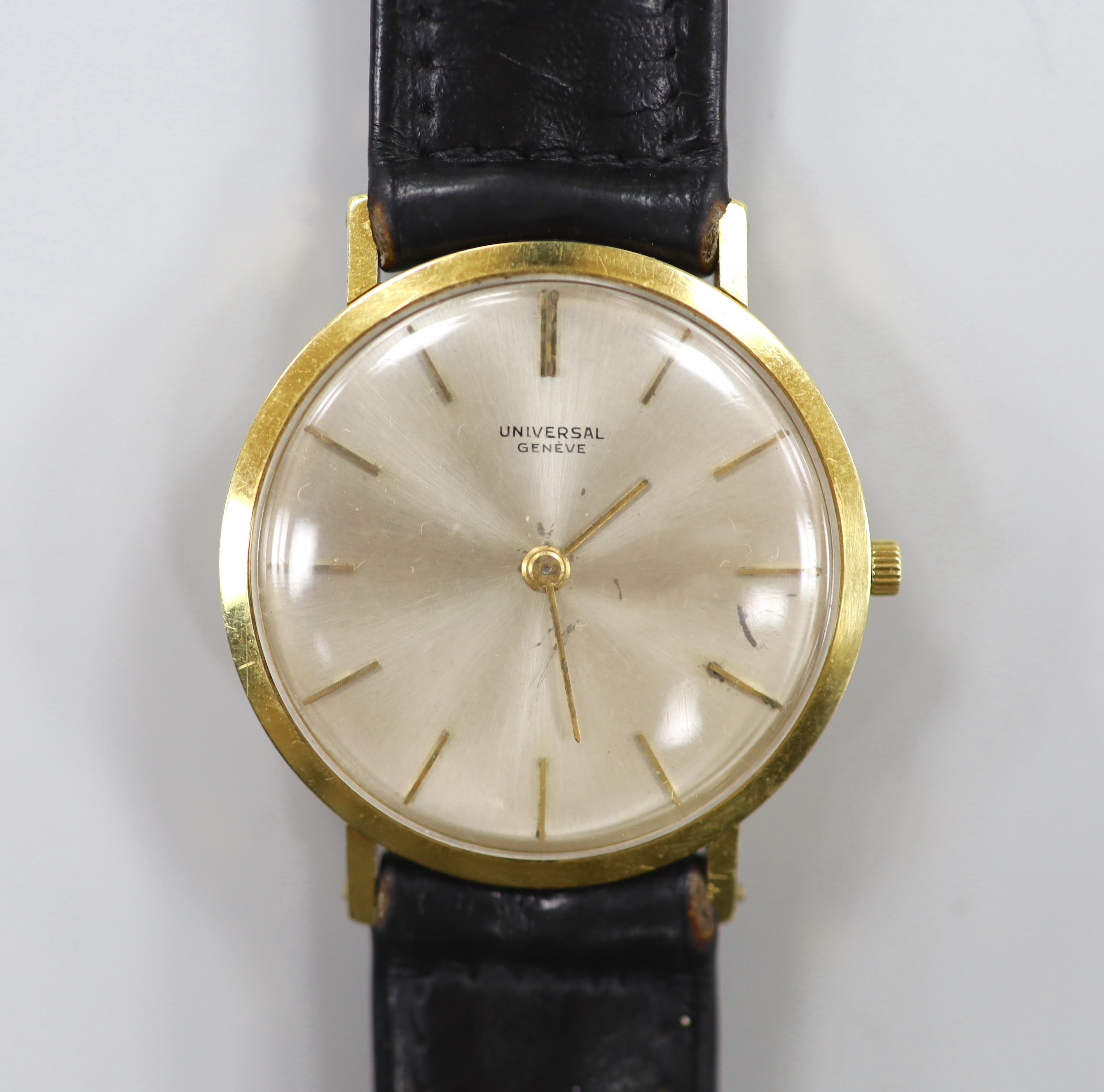 A gentleman's 18ct gold Universal manual wind wrist watch, with baton numerals, on a leather strap with gold plated Universal buckle, gross weight 28.1 grams.